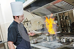 Chef cook doing flambe photo