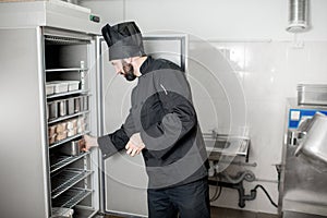 Chef cook getting food from the refrigerator