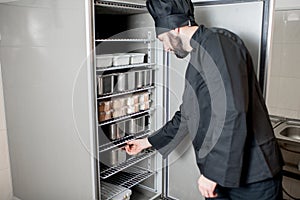 Chef cook getting food from the refrigerator