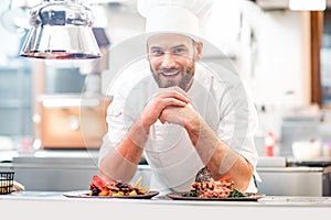 Chef cook at the kitchen photo