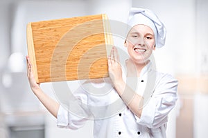 chef cook with wooden cutting board posing