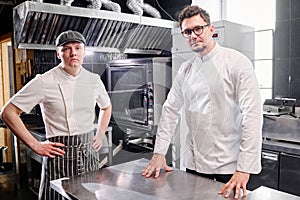 Chef and cook working in kitchen