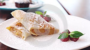 Chef cooking apple strudel with raspberry