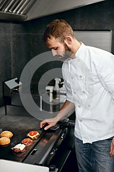 Chef Cooking Burgers in Kitchen