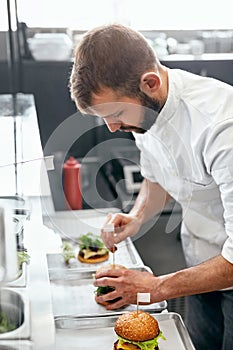 Chef Cooking Burgers in Kitchen