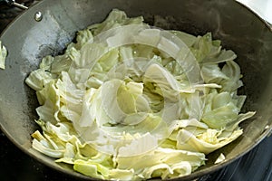 A chef is cooking cabbage