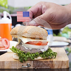 Chef cooking and decorated Hamburger with American Flag