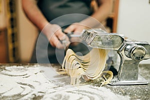 Chef cooking fettuccine in pasta machine