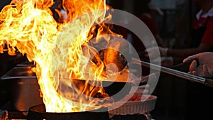 Chef Cooking With Fire In Frying Pan photo