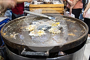 Chef cooking food fry Pan-fried crispy mussel at Street food at Yoawaraj Road