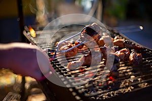 Chef cooking jerk barbecue BBQ chicken on the grill hand turning food