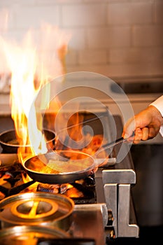 Chef cooking in kitchen stove