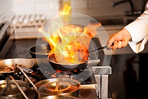 Chef cooking in kitchen stove