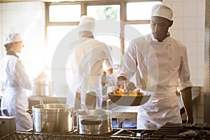 Chef cooking in kitchen stove