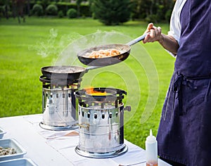 Chef cooking meat on grill