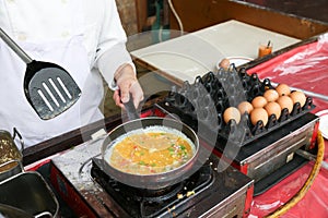 A chef is cooking an omelet