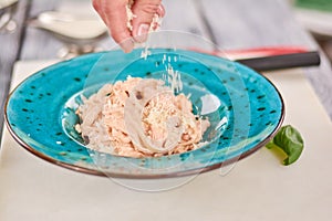 Chef cooking pasta crema di pollo.