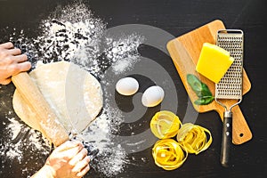 Chef cooking pasta top view on dark background