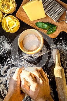 Chef cooking pasta top view on dark background