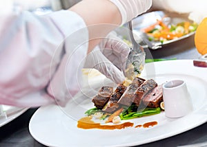 Chef cooking, Chef preparing food in the kitchen, Chef decorating dish, closeup