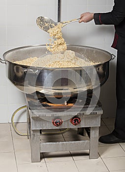 Chef cooking rice at a commercial kitchen
