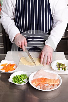 Chef cooking seafood lasagna