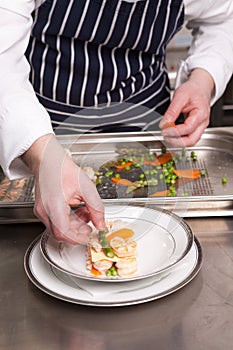 Chef cooking seafood lasagna