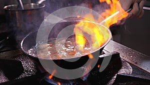 Chef cooking shrimps - flaming the food