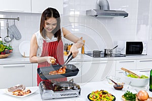 Chef cooking steak in kitchen.