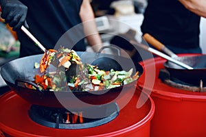 Chef Cooking Thai Dish Closeup At Street Food Festival.