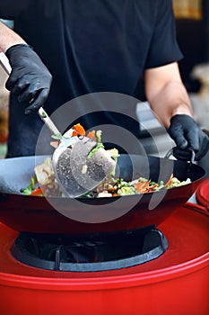 Chef Cooking Thai Dish Closeup At Street Food Festival.