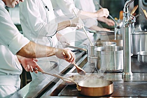 Chef cooking vegetables in wok pan. Shallow dof.