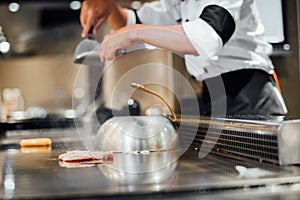 Chef cooking wagyu beef in Japanese teppanyaki restaurant