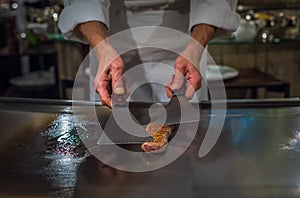 Chef cooking wagyu beef in Japanese teppanyaki restaurant, Tokyo