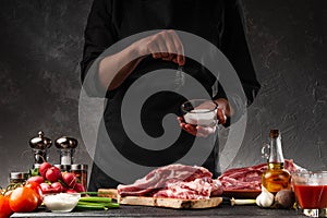 Chef cooks fresh pork or beef ribs. Against the background of vegetables.Sole, freezing motion