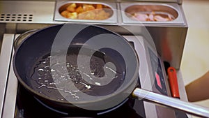 The chef cooks the sunny-side-up eggs in a pan with olive oil.