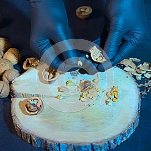 the chef crushes walnuts with his gloved hands