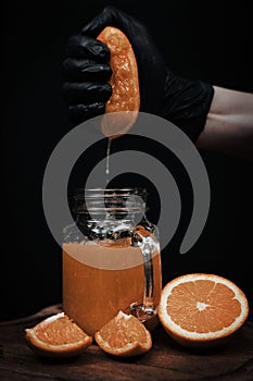 Chef crushing orange in glass
