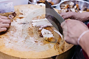 Chef cut crispy belly pork on chopping board