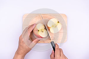 Chef cutting apple before cooking concept on a cutting board  on a white background, Sweet and juicy fruit