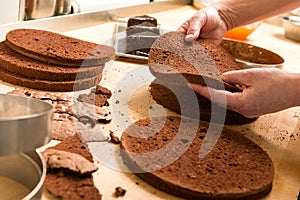 Chef cutting cake layers and stacking them