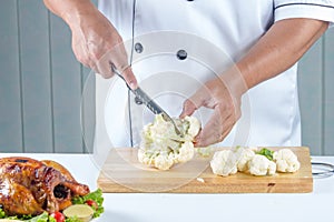 Chef cutting cauliflower