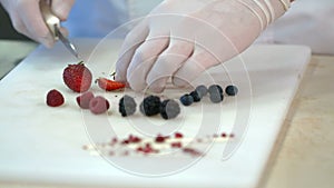 Chef cutting fresh berries at his kitchen