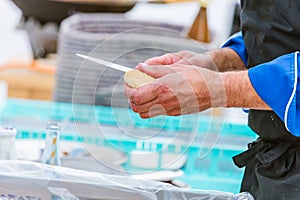 Chef cutting fresh bread for Burger