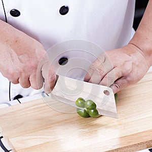Chef cutting green bell pepper