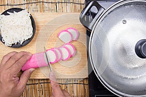 Chef cutting kamaboko Japanese fish cake