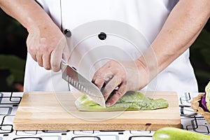 Chef cutting lettuce