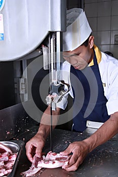 Chef cutting meat