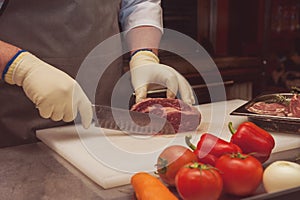 Chef cutting meat