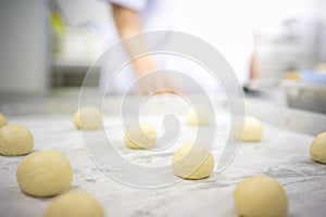 The chef are cutting and molding dough.